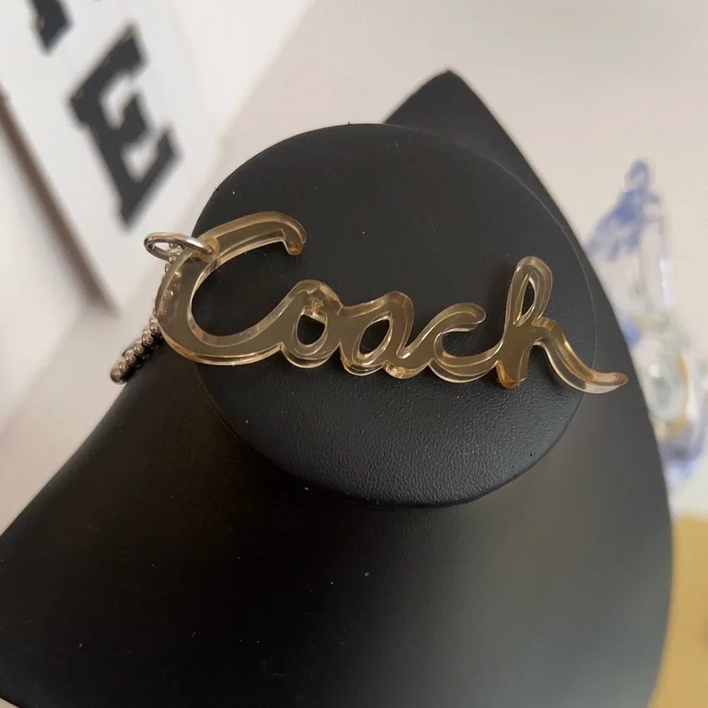 Coach poppy Y2K clear Metallic Gold Script Keychain or bag tag